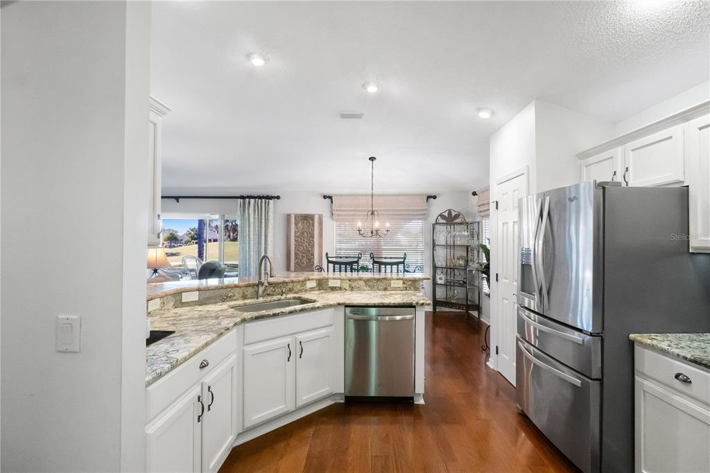 1456 Honea Path The Villages, FL 32162 - Photo 18 of 44 a kitchen with a refrigerator a sink and cabinets
