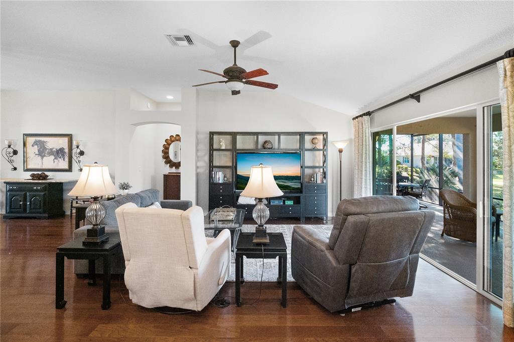 1456 Honea Path The Villages, FL 32162 - Photo 21 of 44 a living room with furniture a couch and a chandelier