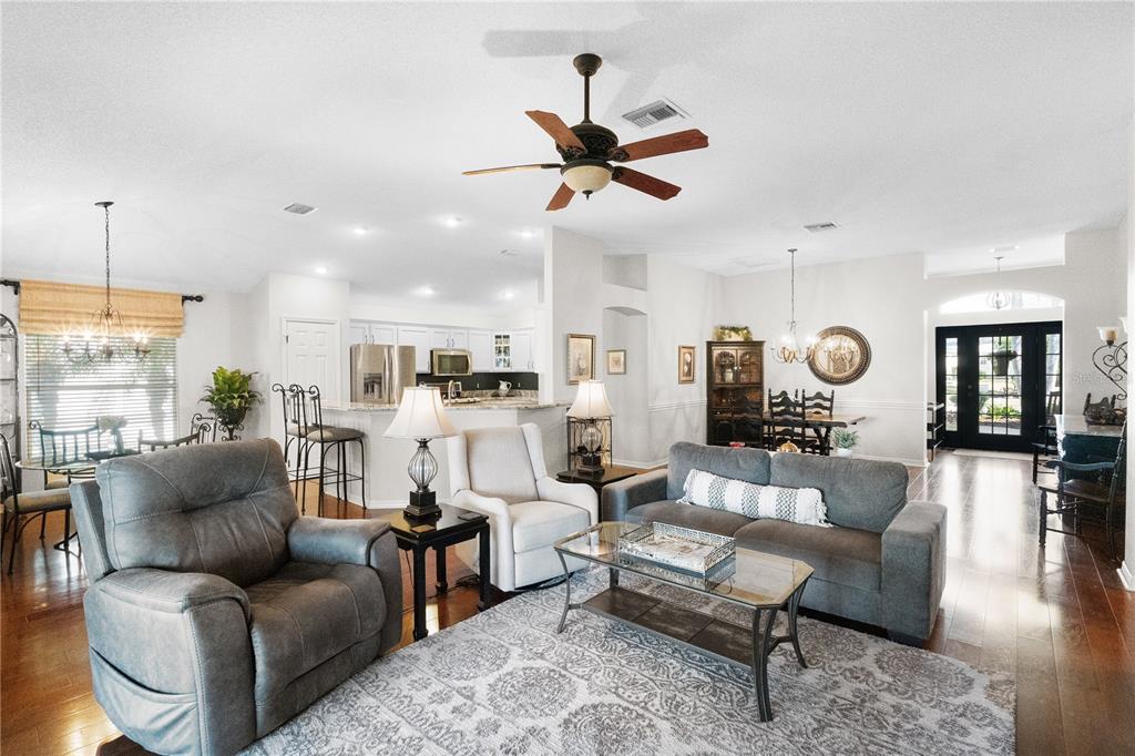 1456 Honea Path The Villages, FL 32162 - Photo 23 of 44 a living room with furniture kitchen view and a chandelier