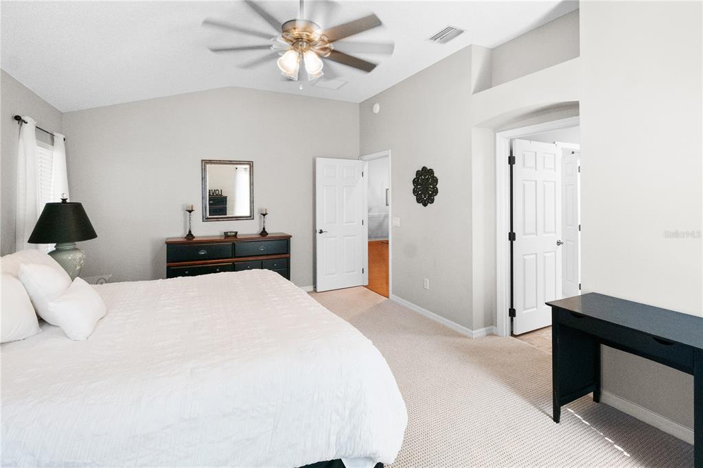 1456 Honea Path The Villages, FL 32162 - Photo 34 of 44 a bedroom with a bed and a chandelier
