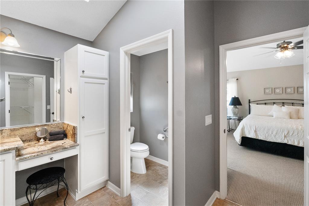 1456 Honea Path The Villages, FL 32162 - Photo 36 of 44 a en suite bathroom with a granite countertop sink and a mirror