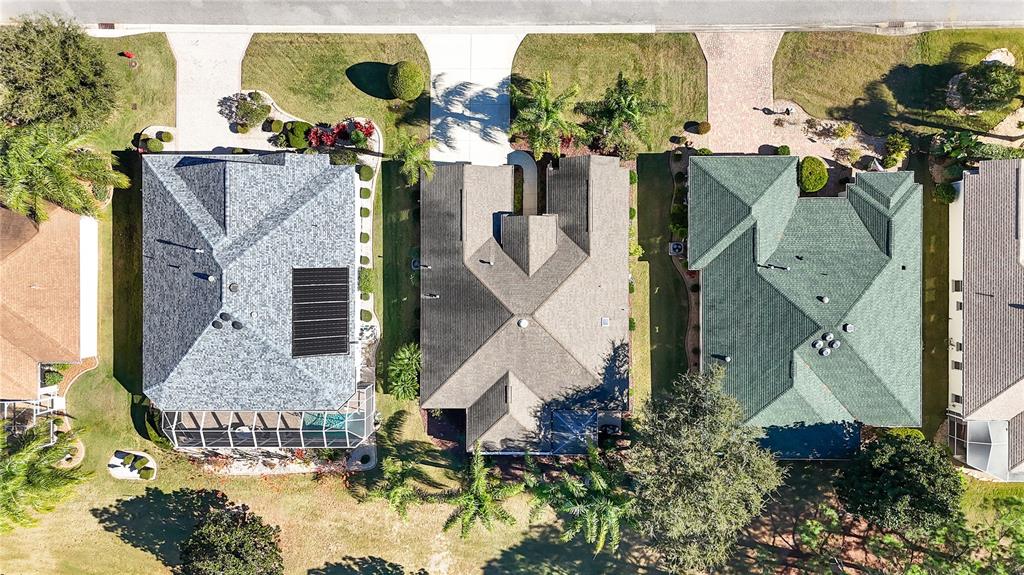 1456 Honea Path The Villages, FL 32162 - Photo 44 of 44 an aerial view of a house with a yard and large trees