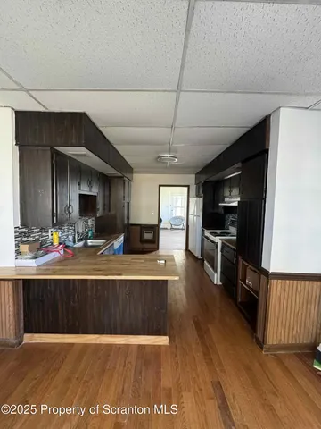 a view of a living room kitchen and a wooden floor