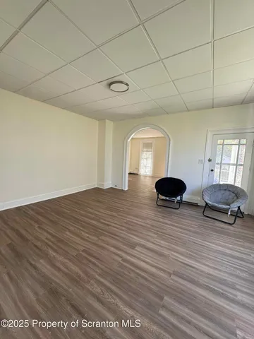 a living room with furniture a window and a wooden floor