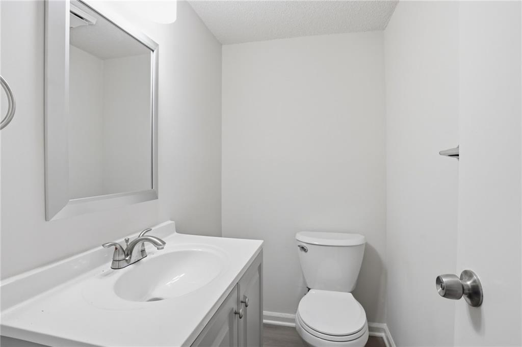 413 Promenade Court Marietta, GA 30064 - Photo 15 of 28 a bathroom with a sink a toilet and a mirror
