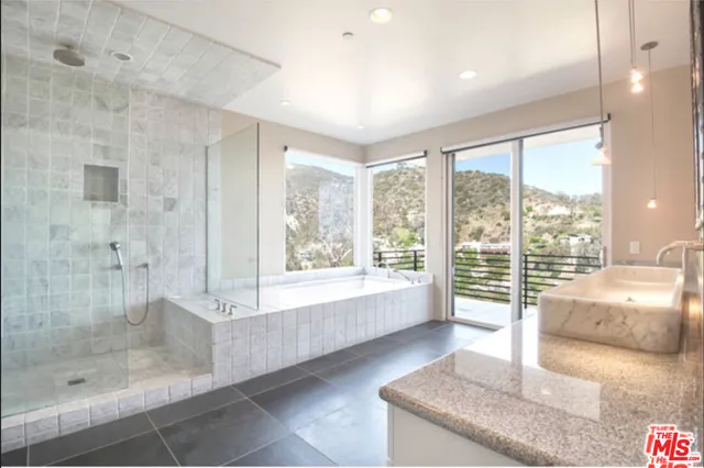 a bathroom with a bathtub and a large window