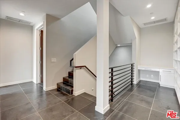 a view of a room with wooden floor
