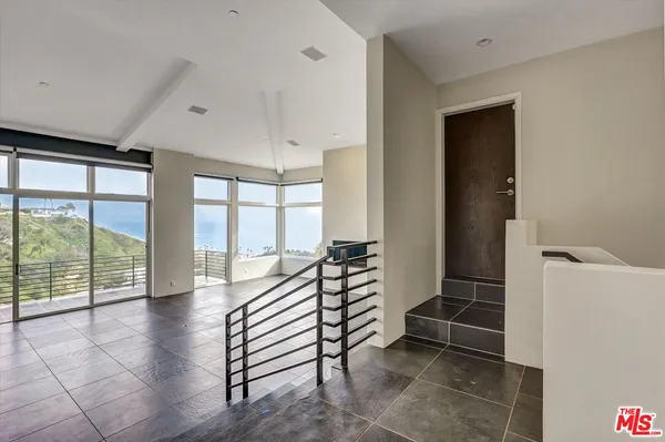a view of entryway with stairs and wooden floor