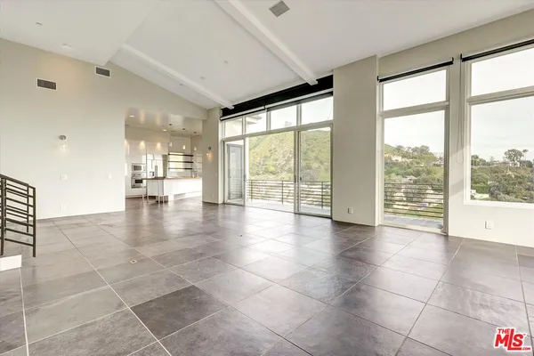a view of a livingroom with furniture and a window