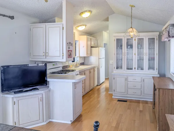 a kitchen with cabinets a sink and appliances