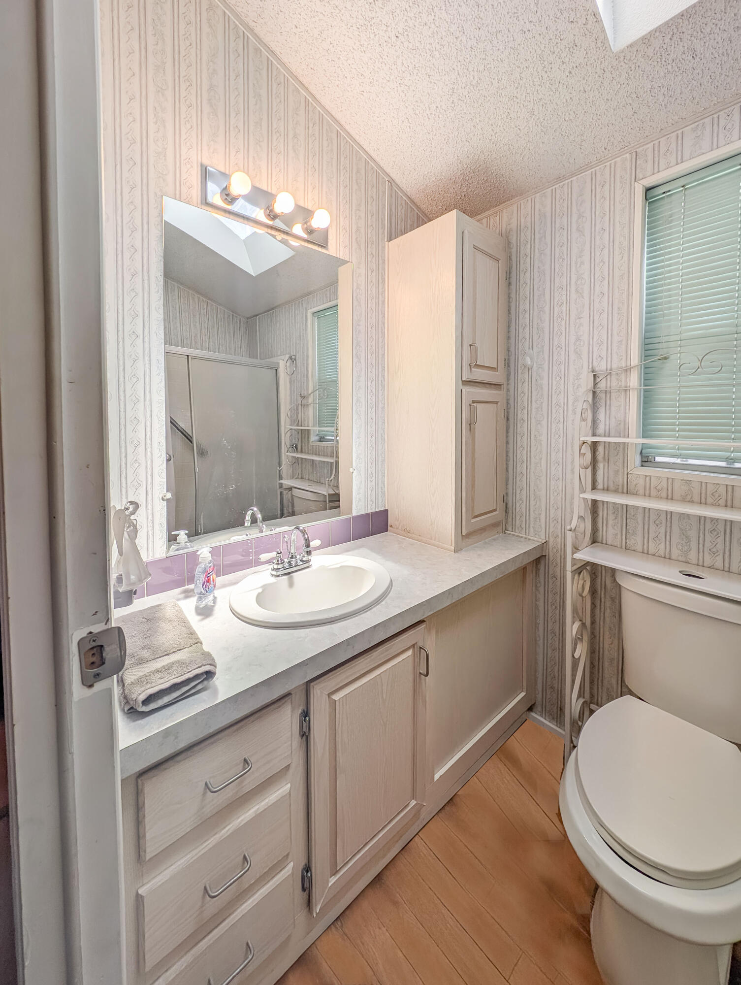 70200 Dillon Road, Unit 517 Desert Hot Springs, CA 92241 - Photo 17 of 32 a bathroom with a toilet a sink and mirror