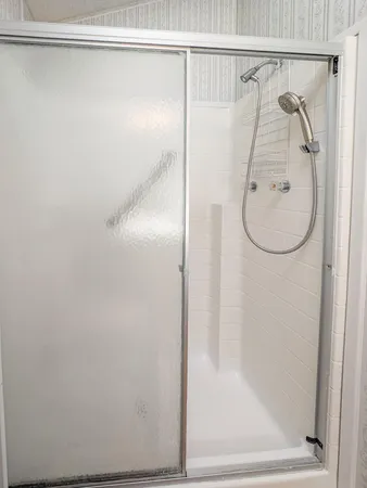 a bathroom with a glass shower door
