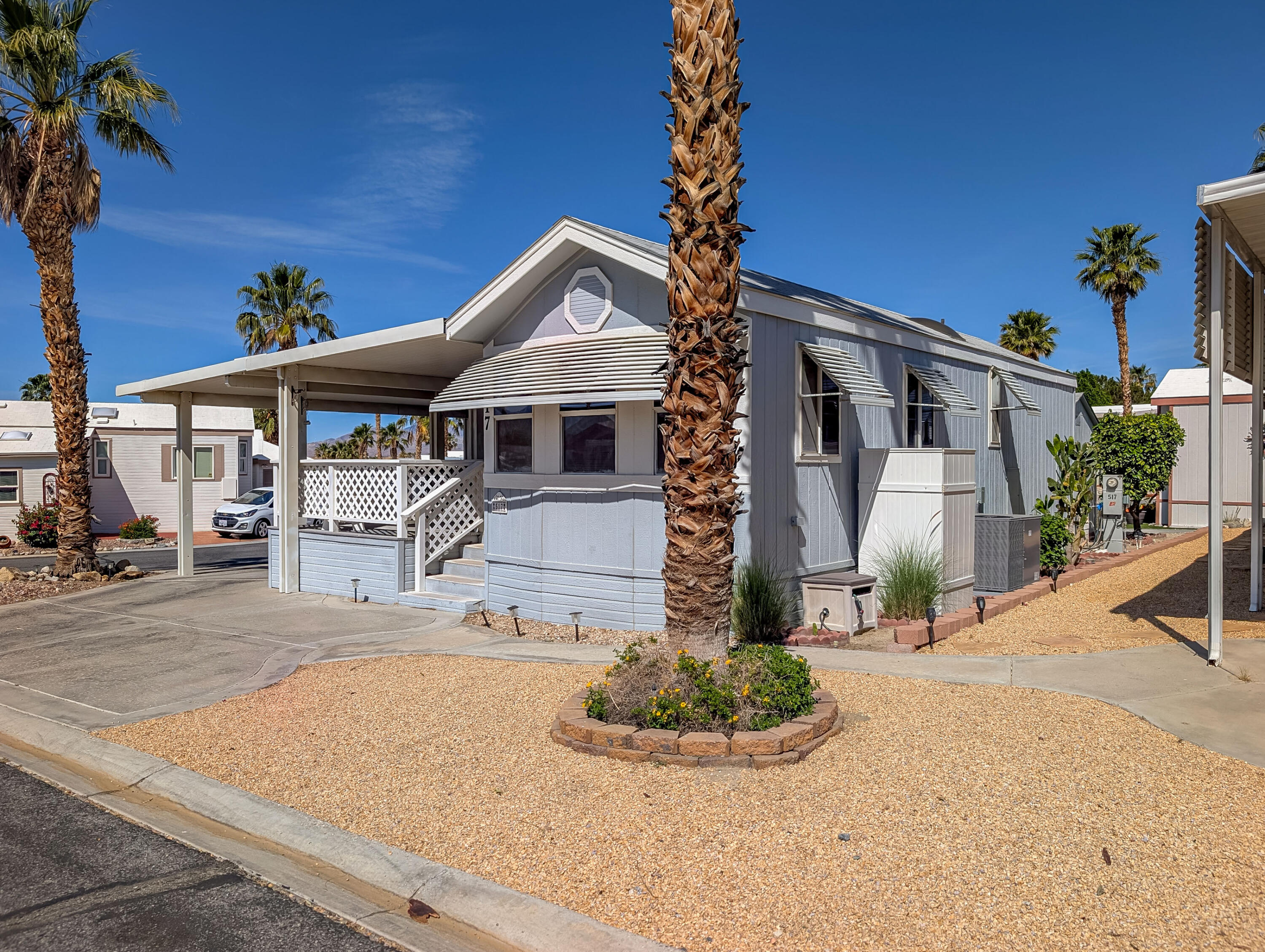 70200 Dillon Road, Unit 517 Desert Hot Springs, CA 92241 - Photo 2 of 32 a front view of a house with garden