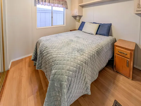 a bedroom with bed and window