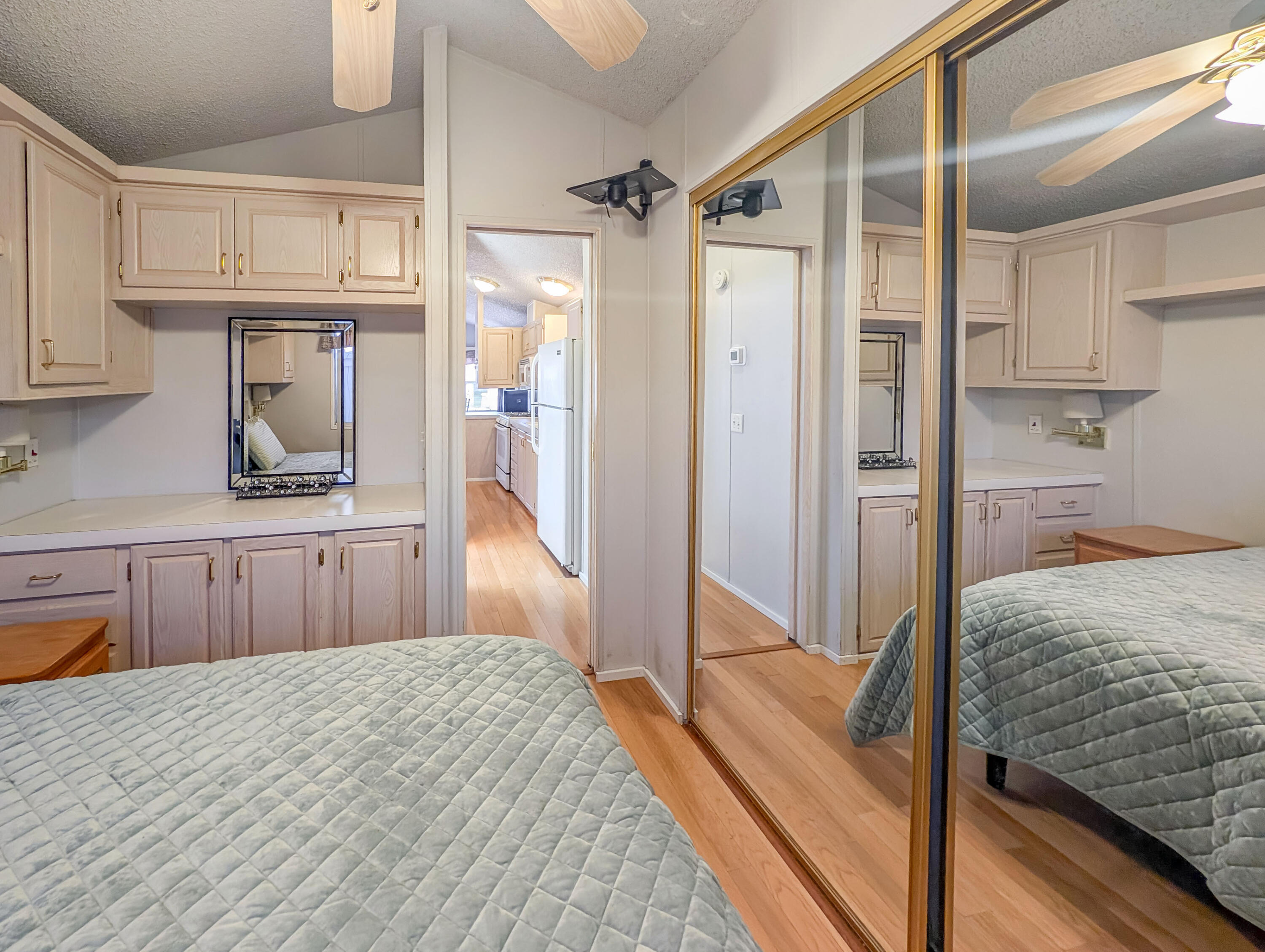 70200 Dillon Road, Unit 517 Desert Hot Springs, CA 92241 - Photo 23 of 32 a bedroom with a bed and a dresser
