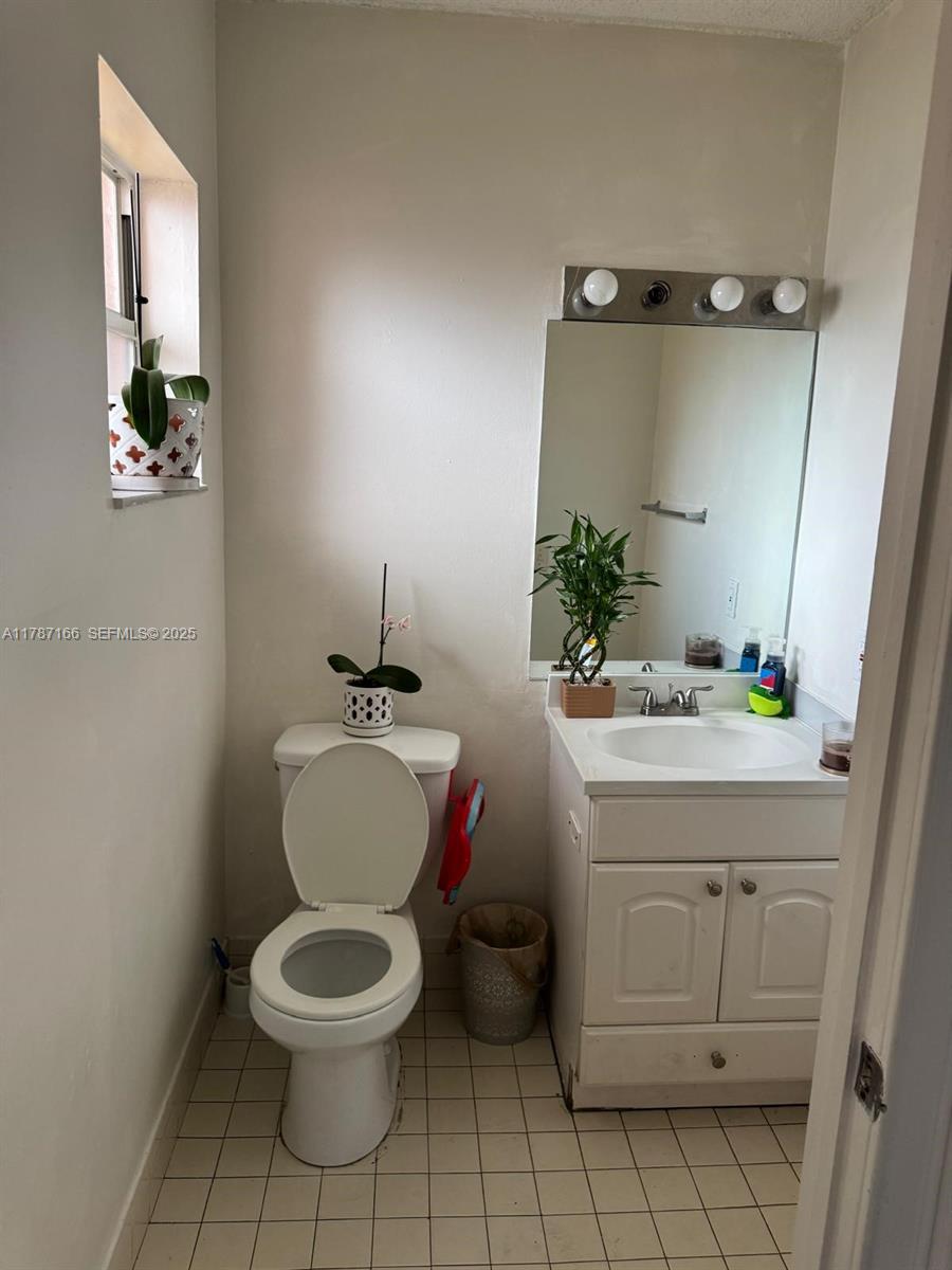 12355 Northwest 7th Lane Miami, FL 33182 - Photo 2 of 21 a bathroom with a toilet sink and mirror