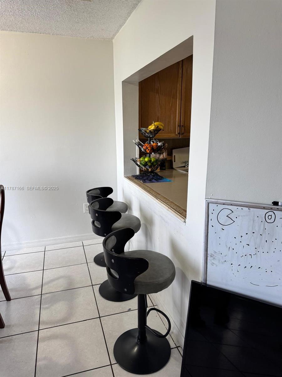 12355 Northwest 7th Lane Miami, FL 33182 - Photo 9 of 21 a dining room with furniture and a potted plant