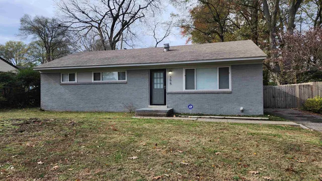 a house that has a tree in front of it