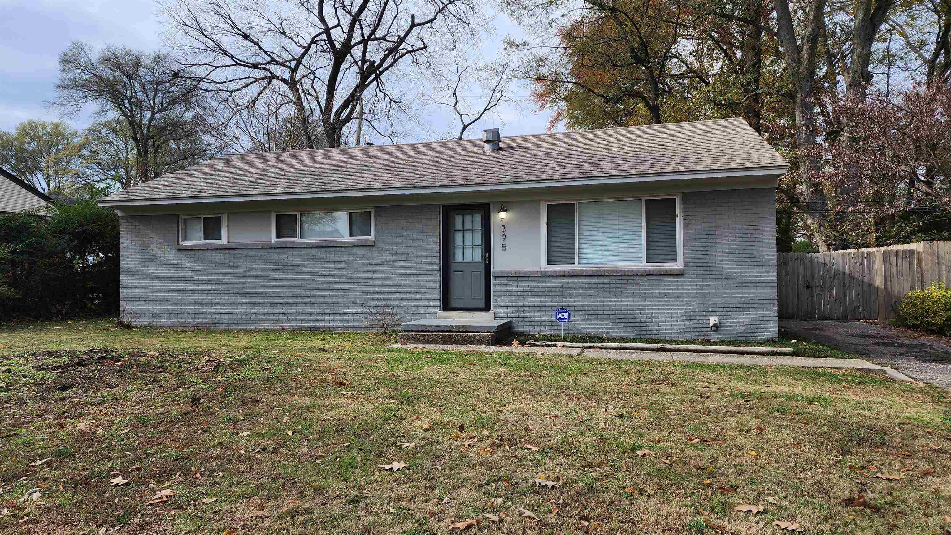 a house that has a tree in front of it