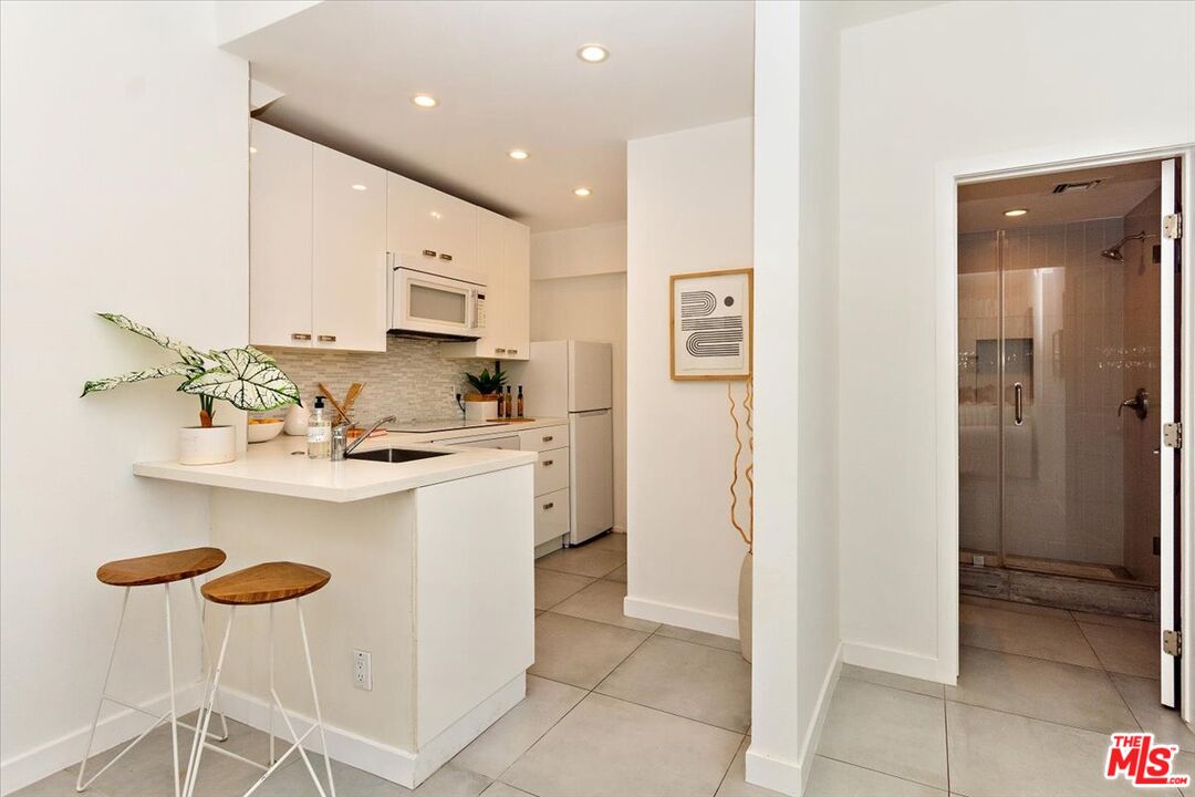 20 Ironsides Street, Unit 3 Marina del Rey, CA 90292 - Photo 27 of 32 a kitchen with stainless steel appliances granite countertop a sink and a refrigerator