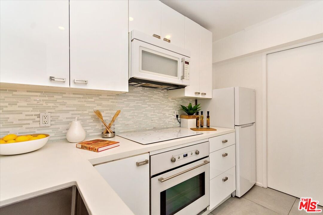 20 Ironsides Street, Unit 3 Marina del Rey, CA 90292 - Photo 28 of 32 a kitchen with sink refrigerator and stove
