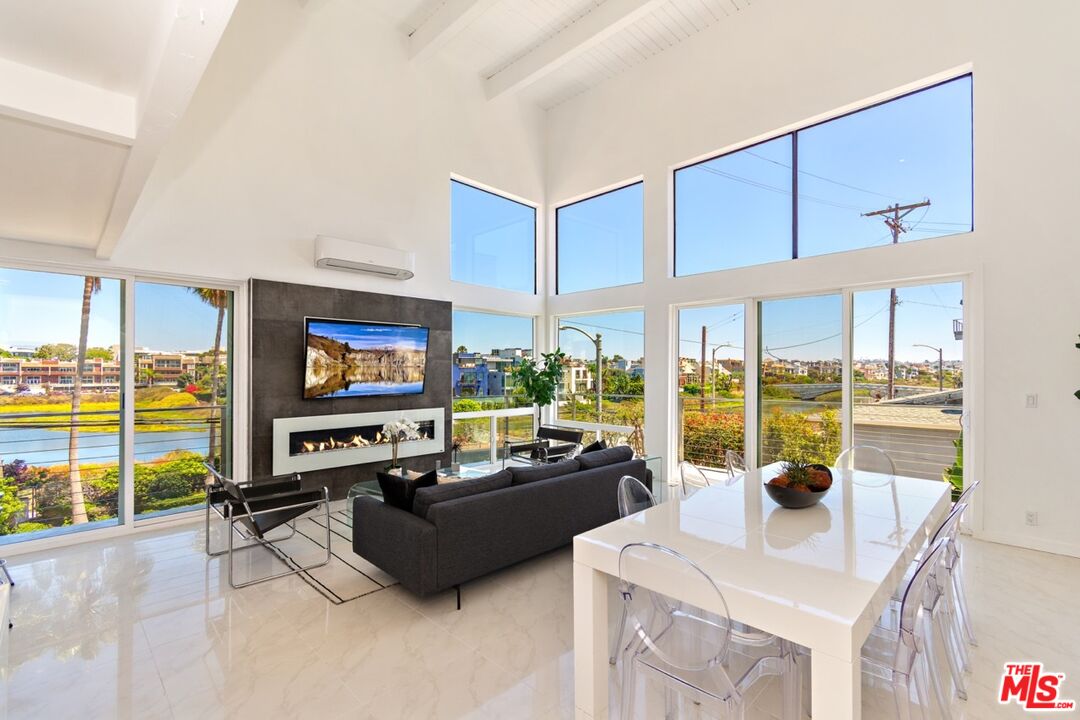 20 Ironsides Street, Unit 3 Marina del Rey, CA 90292 - Photo 5 of 32 a living room with furniture a flat screen tv and floor to ceiling window