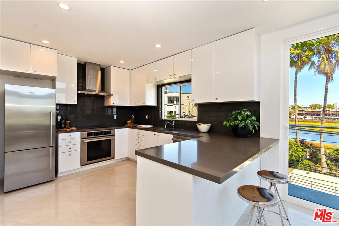 20 Ironsides Street, Unit 3 Marina del Rey, CA 90292 - Photo 7 of 32 a kitchen with stainless steel appliances granite countertop a refrigerator sink and stove