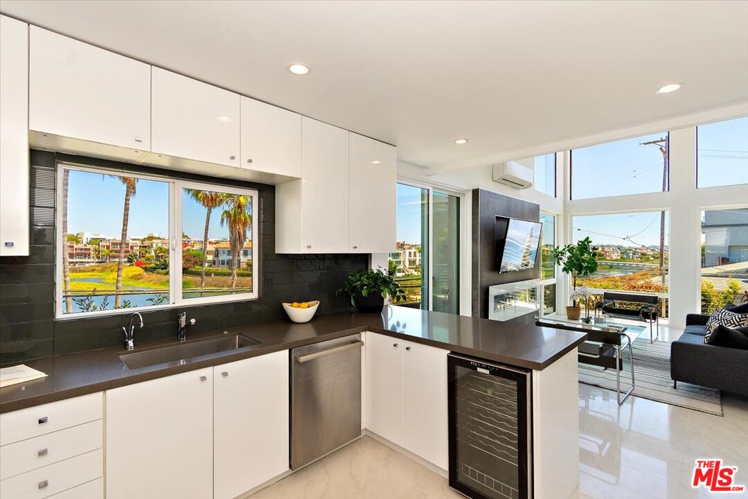 20 Ironsides Street, Unit 3 Marina del Rey, CA 90292 - Photo 9 of 32 a kitchen with stainless steel appliances a sink stove and cabinets