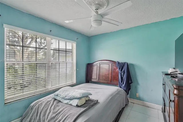 a bedroom with a large bed and a large window