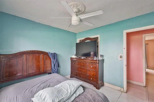 a bedroom with a bed and a television