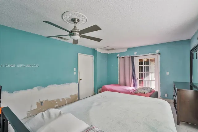 a bed sitting in a bedroom next to a window