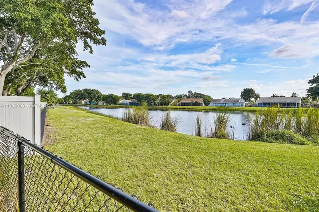 a view of a lake with houses in the background