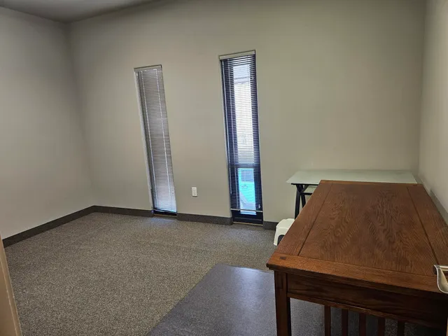 a living room with furniture and a chair