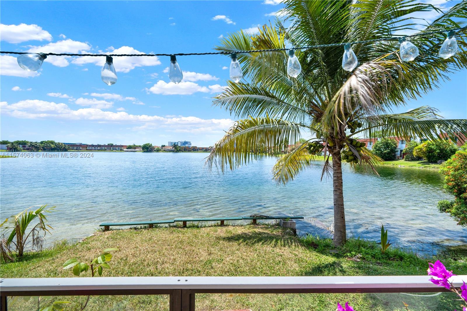 10810 Northwest 7th Street, Unit 6B Miami, FL 33172 - Photo 1 of 19 a view of a swimming pool with a table and chairs