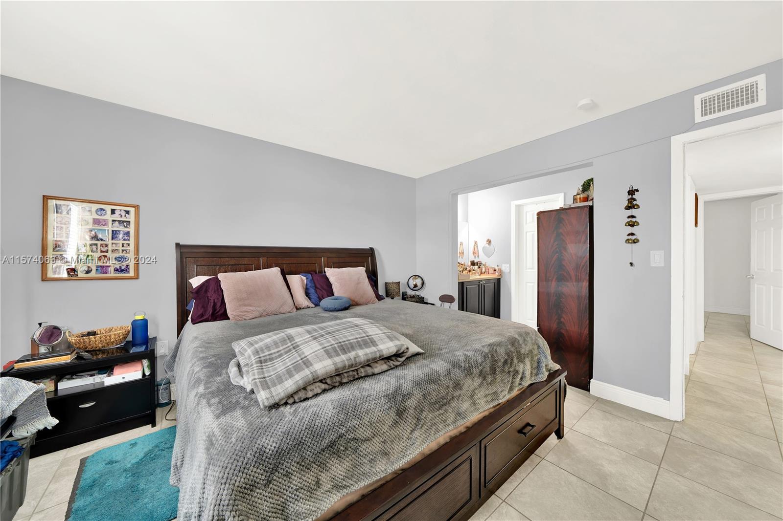10810 Northwest 7th Street, Unit 6B Miami, FL 33172 - Photo 12 of 19 a bedroom with a bed and a view of bedroom