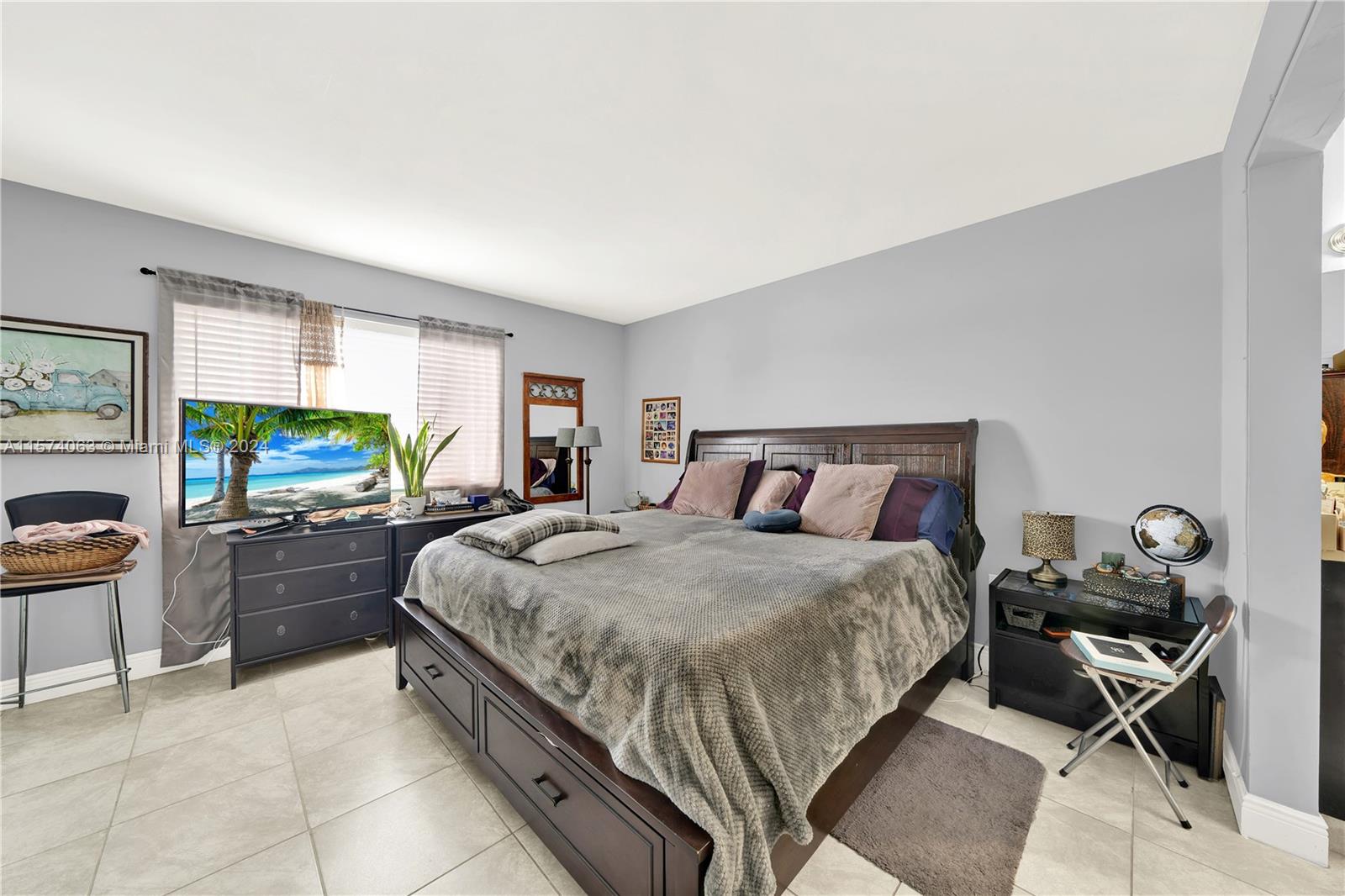 10810 Northwest 7th Street, Unit 6B Miami, FL 33172 - Photo 13 of 19 a bed room with a bed and furniture