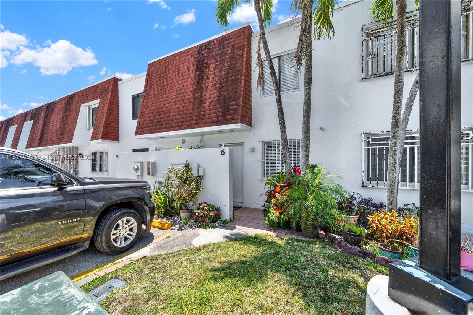 10810 Northwest 7th Street, Unit 6B Miami, FL 33172 - Photo 2 of 19 a view of a car park in front of a building
