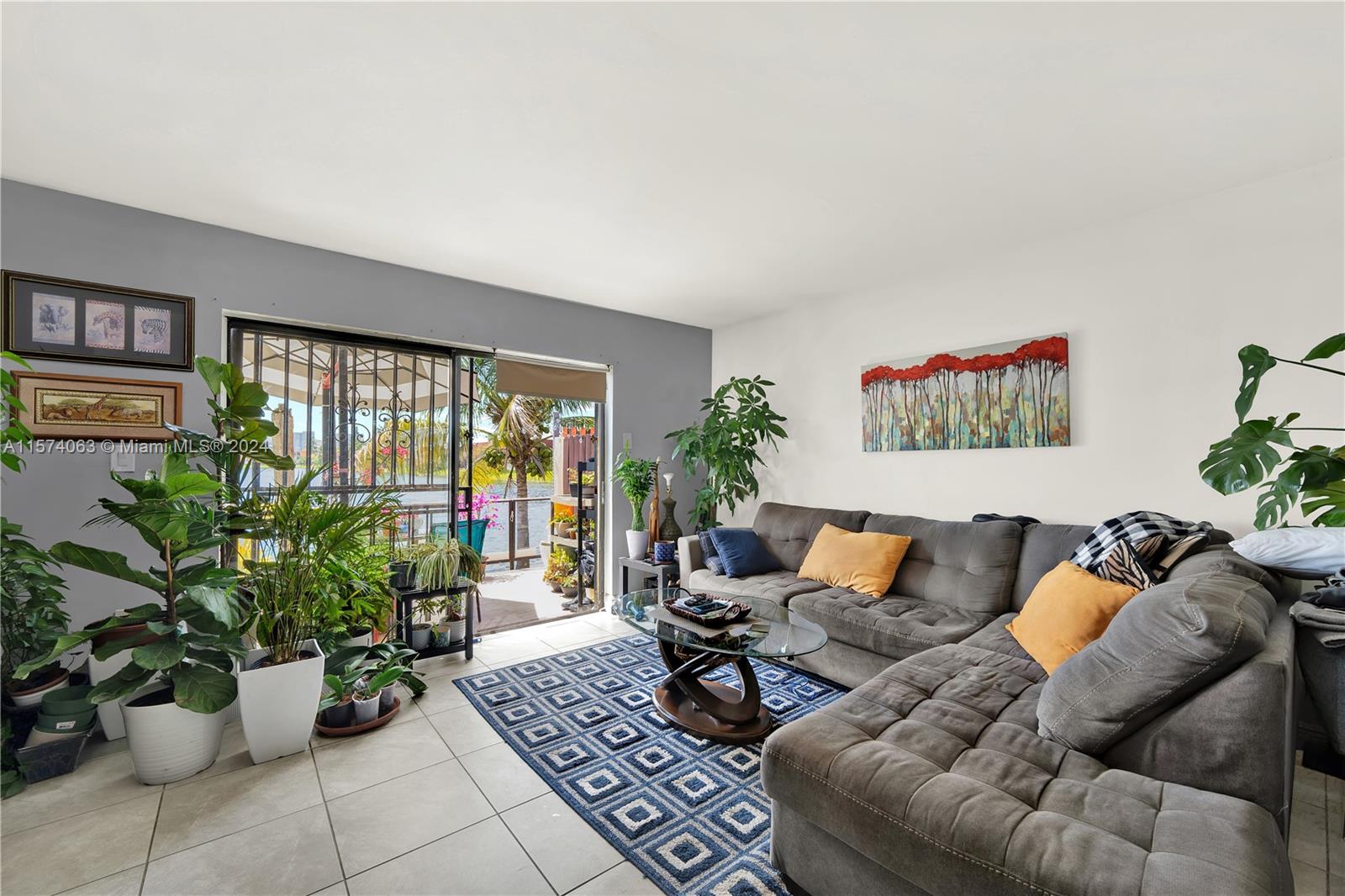 10810 Northwest 7th Street, Unit 6B Miami, FL 33172 - Photo 4 of 19 a living room with furniture and flowers