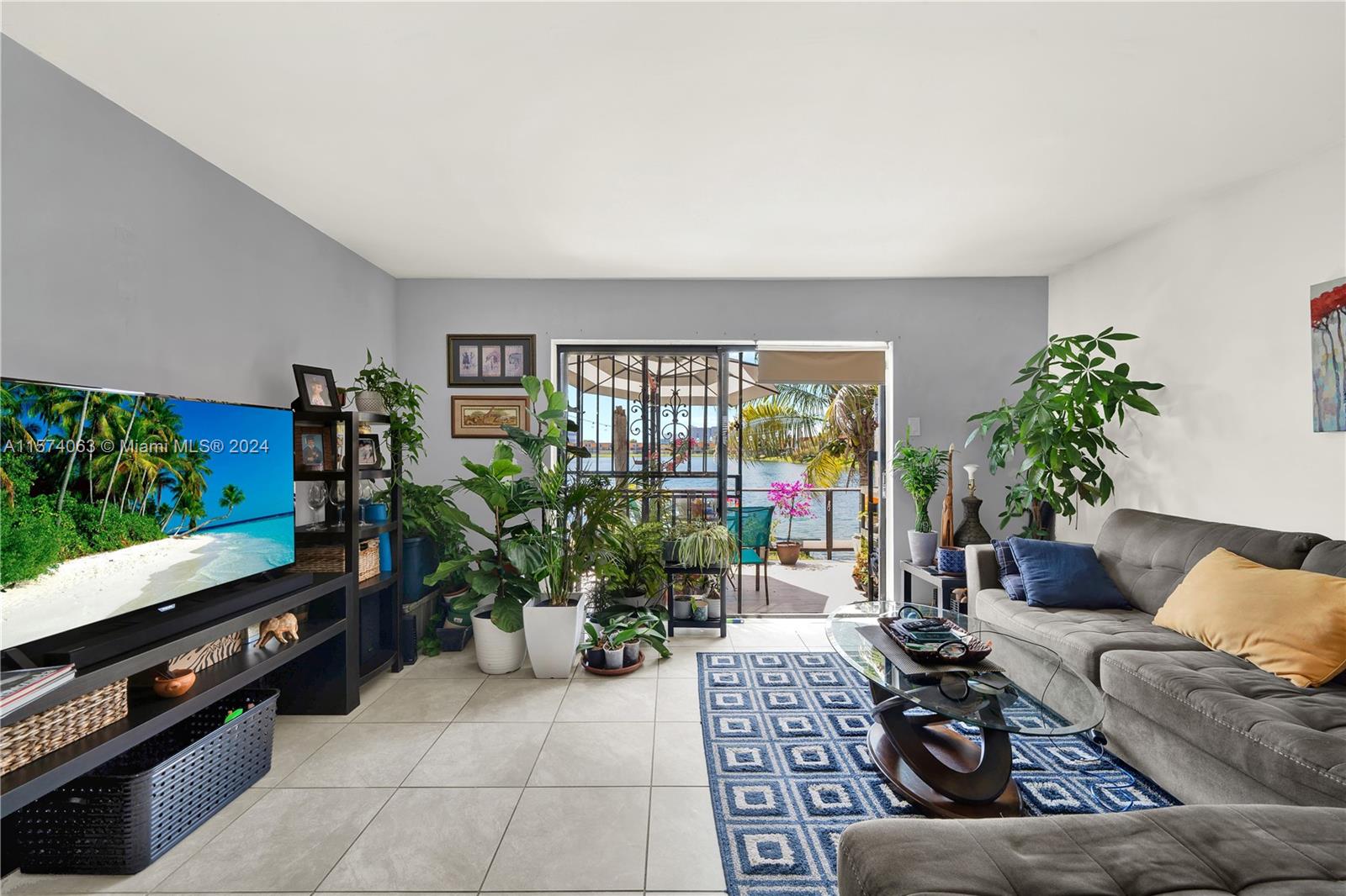 10810 Northwest 7th Street, Unit 6B Miami, FL 33172 - Photo 5 of 19 a living room with furniture and a flat screen tv