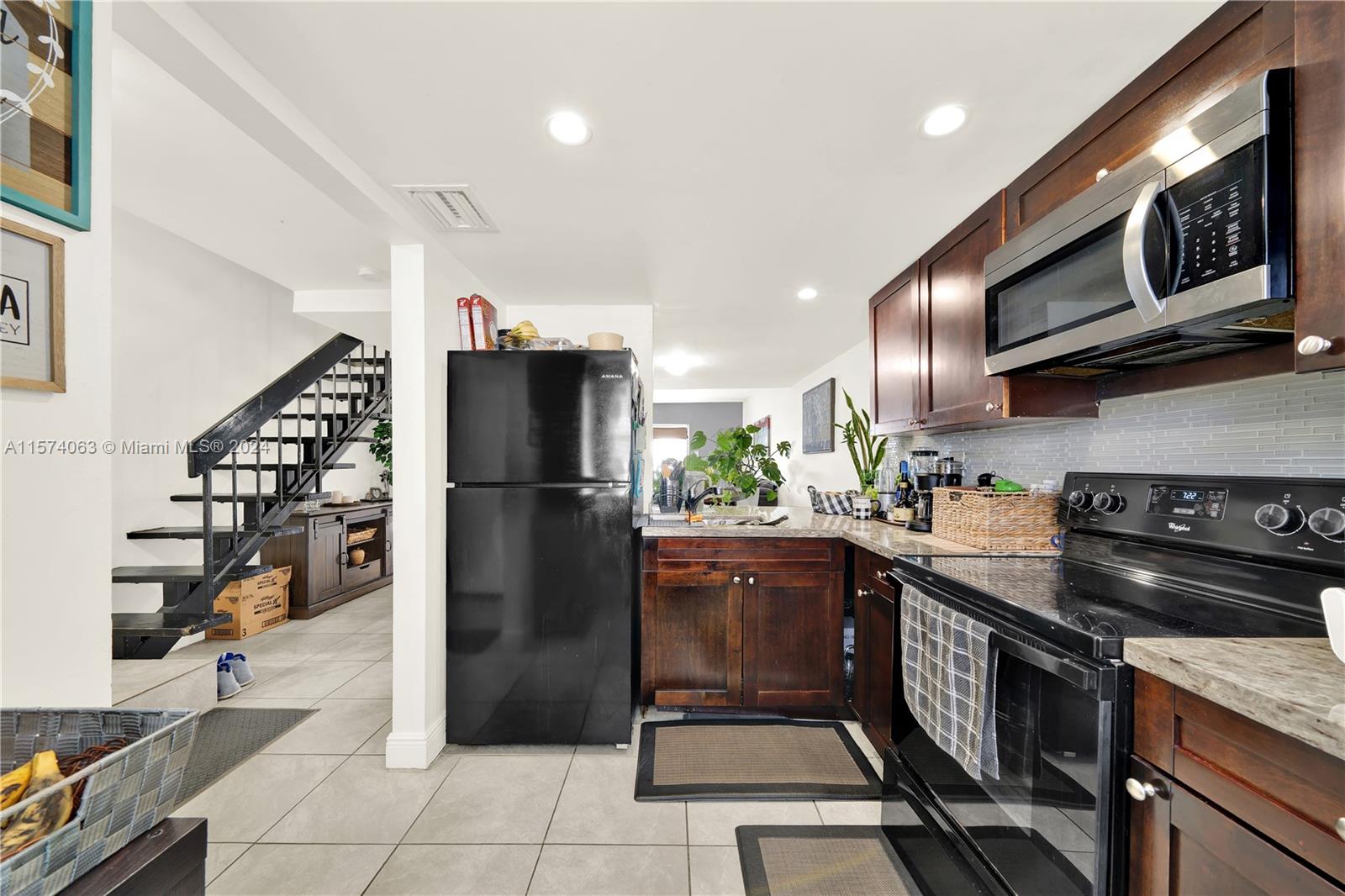 10810 Northwest 7th Street, Unit 6B Miami, FL 33172 - Photo 6 of 19 a kitchen with stainless steel appliances granite countertop a stove a refrigerator and a sink