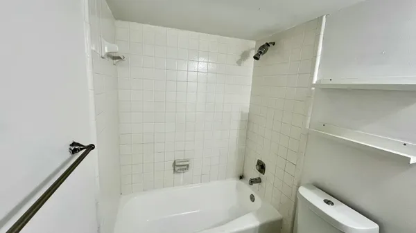 a bathroom with a bathtub and shower