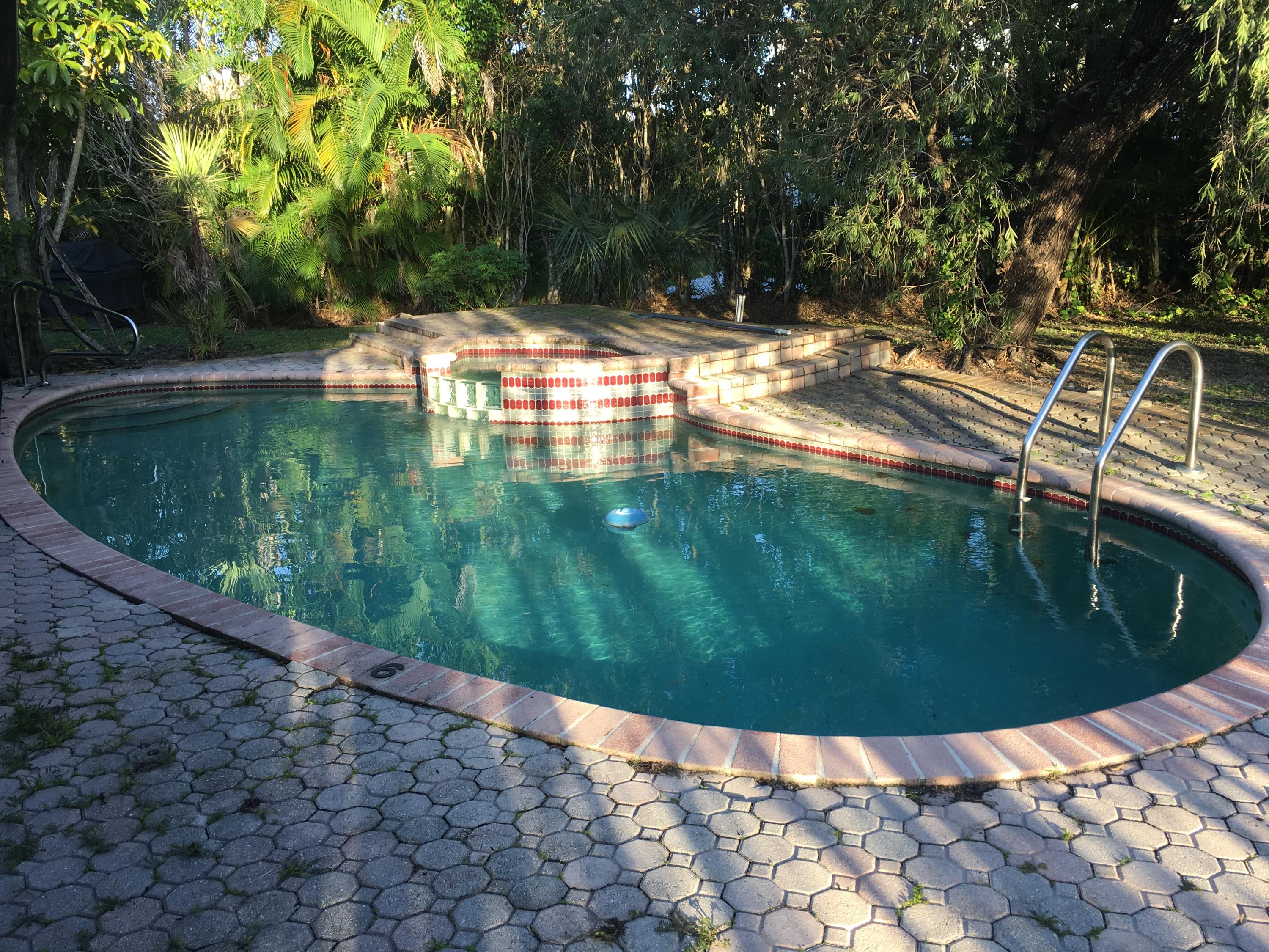 22146 Candle Court Boca Raton, FL 33428 - Photo 19 of 24 a view of a swimming pool with a yard