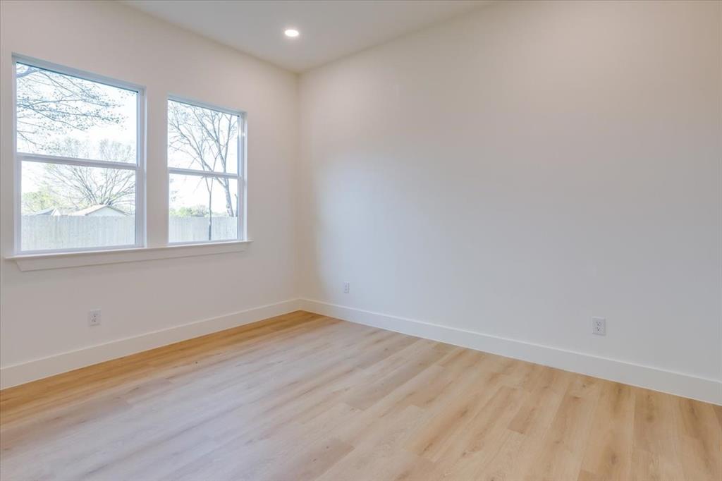 1507 Elk Creek Road Dallas, TX 75253 - Photo 25 of 40 an empty room with wooden floor and windows
