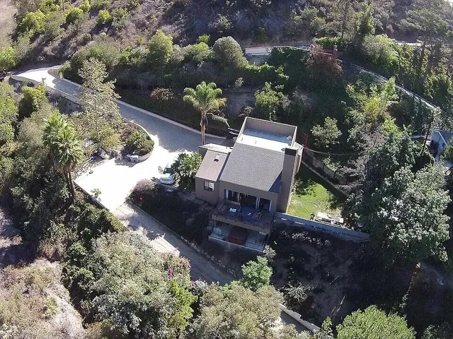 an aerial view of a house with a yard