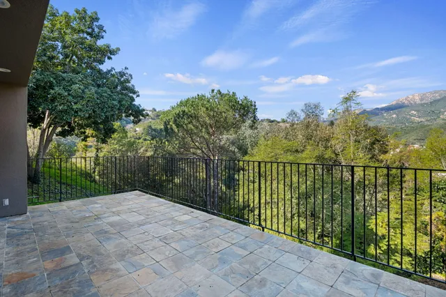 a balcony with trees in front of it