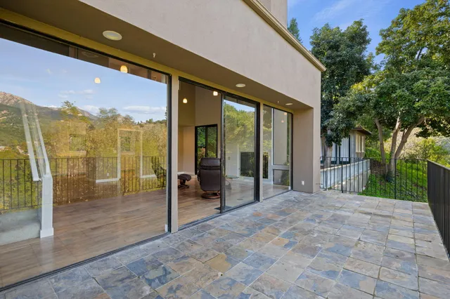 a kitchen with granite countertop a stove a sink and white cabinets with wooden floor