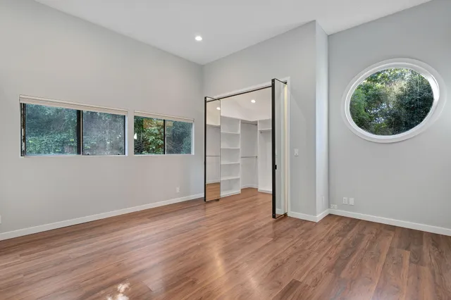 a view of walk in closet with wooden floor