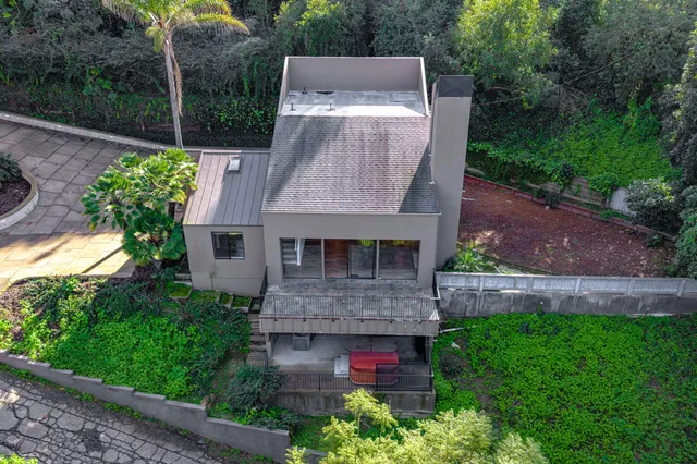 an aerial view of a house with a yard and potted plants