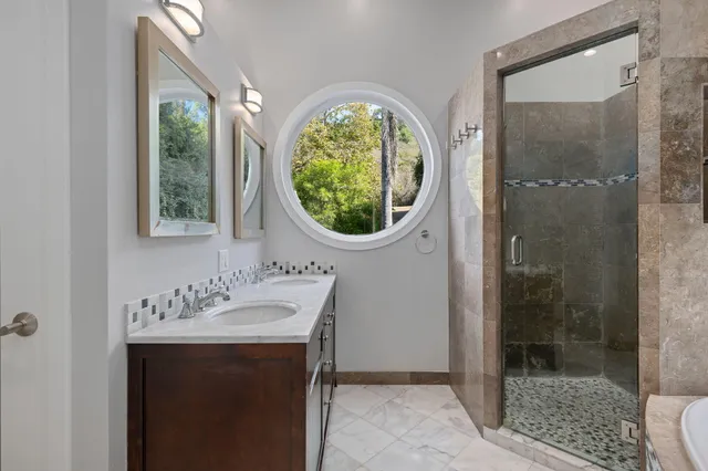 a bathroom with a bathtub and shower