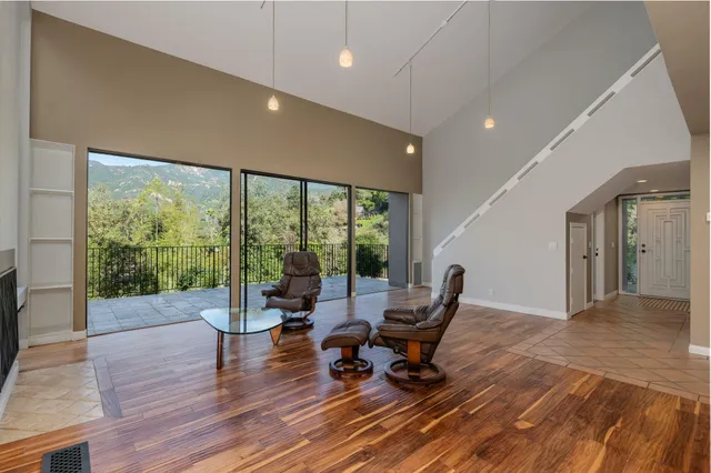 a living room with furniture and a floor to ceiling window